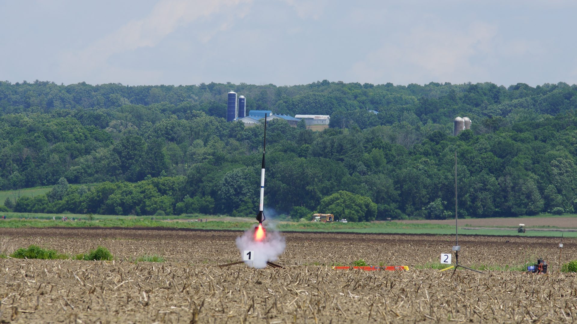 Rocket launch plume against blue sky